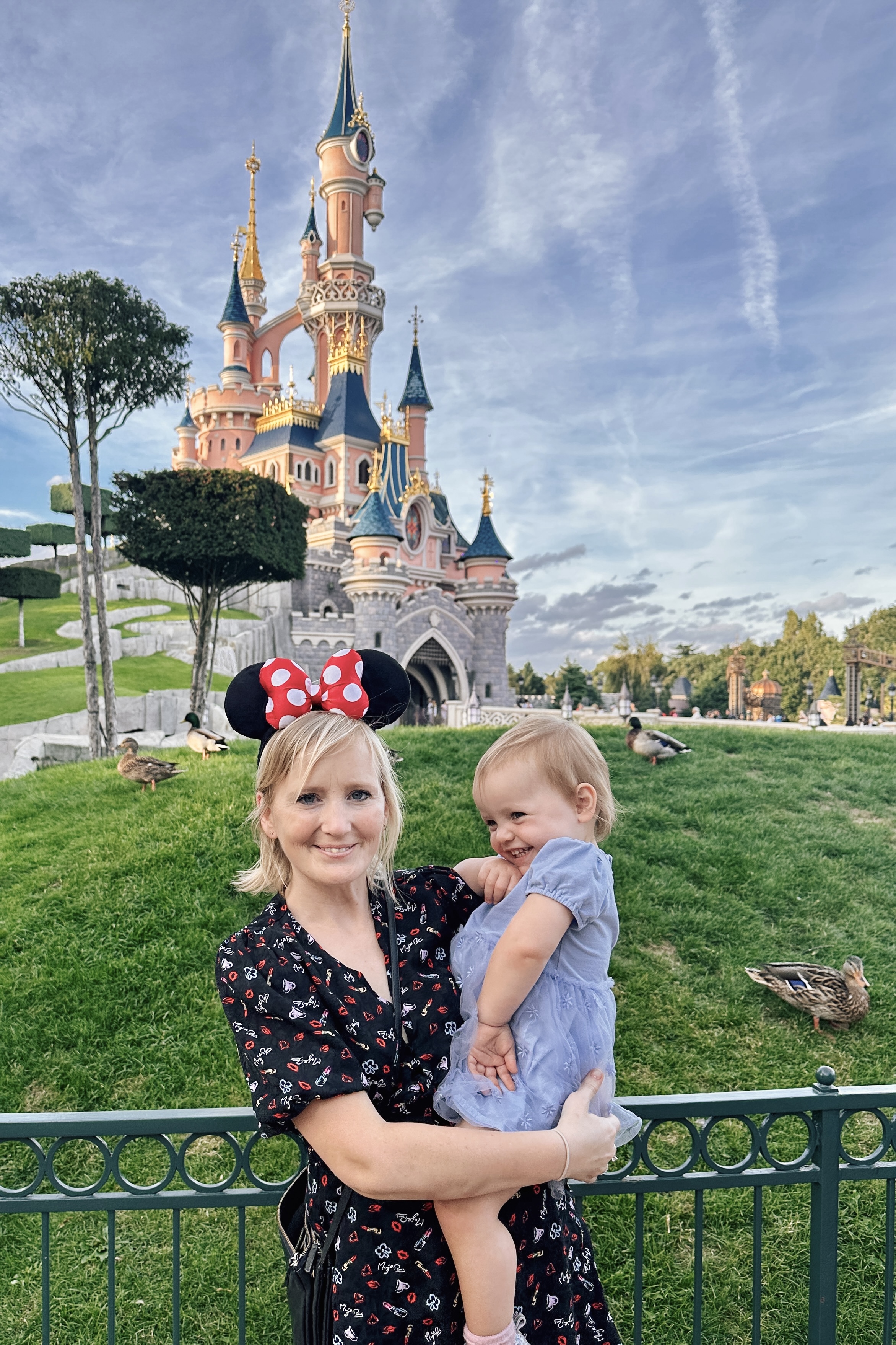 Me holding Kaydes infront of Disneyland Paris' Sleeping Beauty Castle